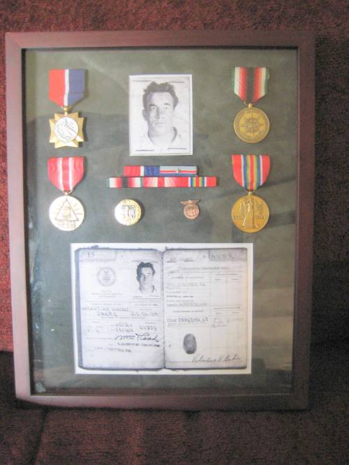 Shadowbox display of Valentine Vincent Baker's medals and images from his Merchant Marine Continuous Service Discharge Book , (Keith Olson photo)